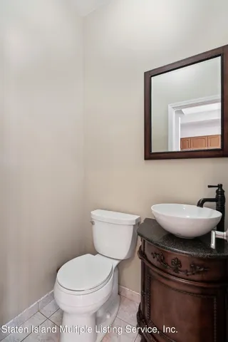 a bathroom with a toilet a sink and mirror