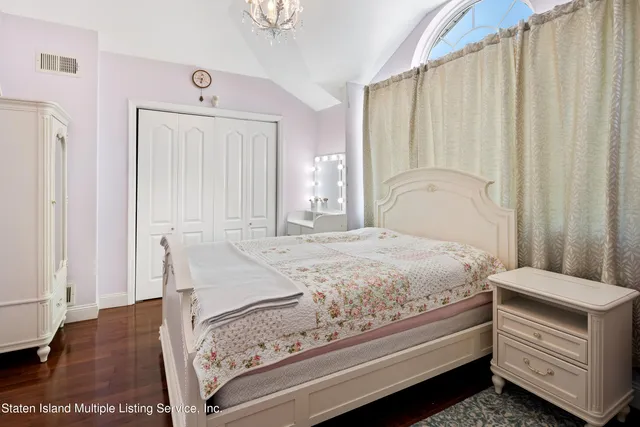 a bedroom with a bed and a dresser