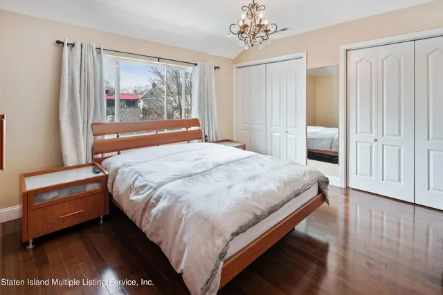 a bedroom with bed and window