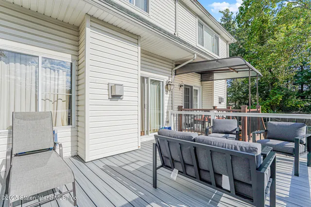 a balcony with furniture and wooden floor