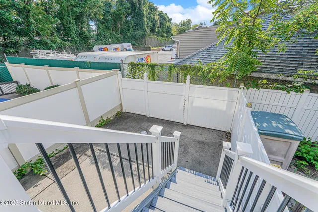 a view of a balcony with floor to ceiling windows