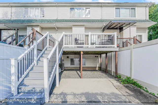 a balcony with table and chairs