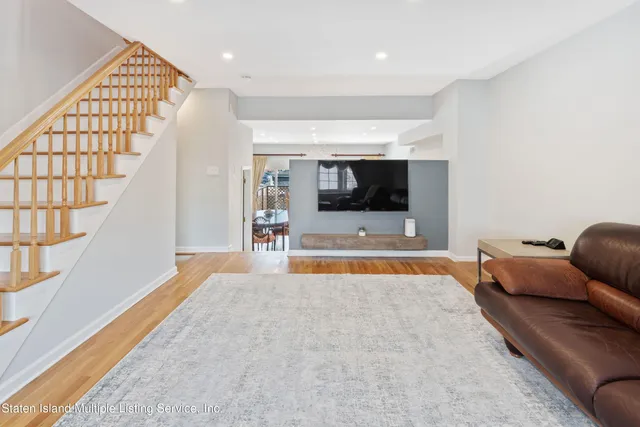 a view of room with furniture and wooden floor