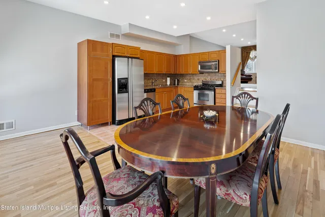 a dining room with furniture and wooden floor