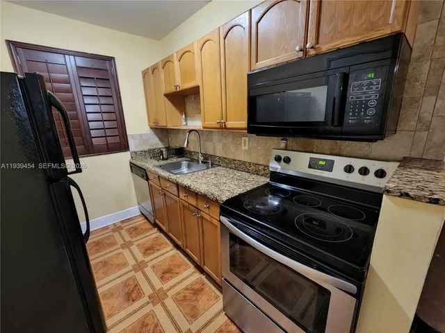 a kitchen with a stove and a microwave