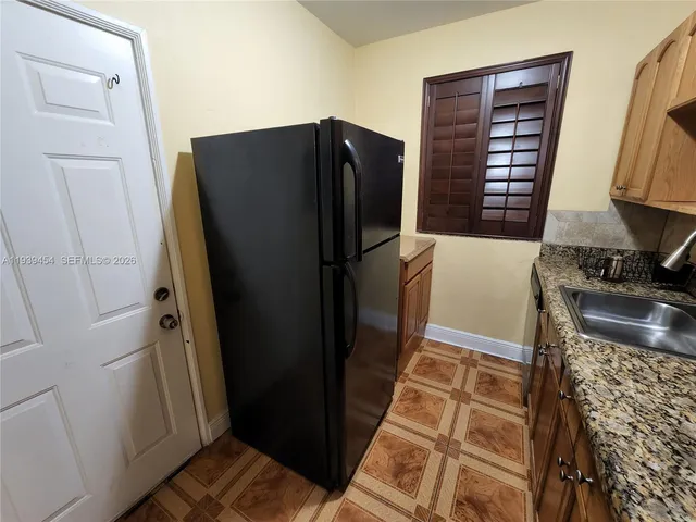 a kitchen with a refrigerator and a stove