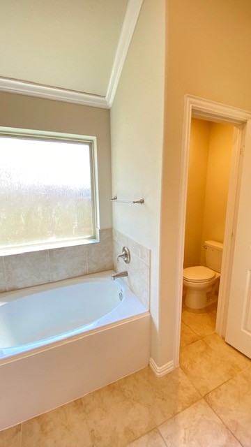 5002 Naples Grove Lane Rosharon, TX 77583 - Photo 27 of 38 Bright bathroom with a large soaking tub, natural light from a frosted window, and a separate toilet area for added privacy.