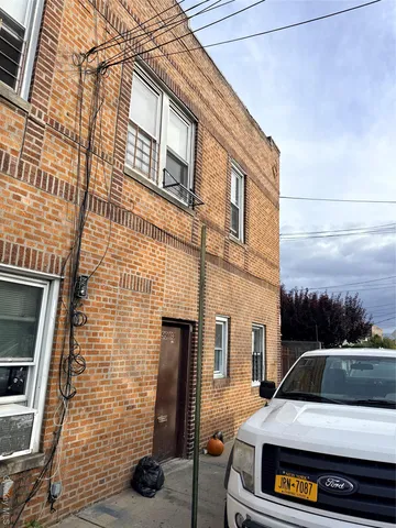 a car parked in front of a brick building