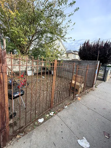 a view of street with wooden fence