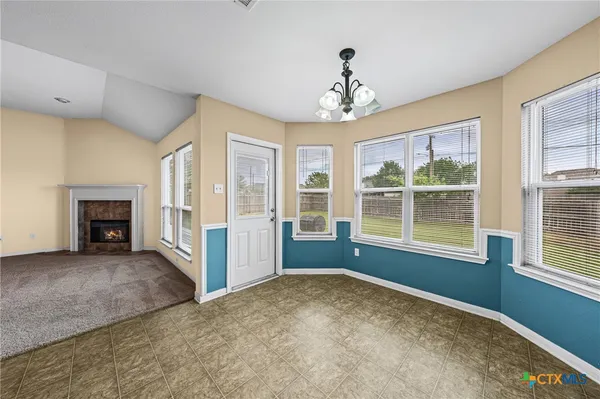 a view of livingroom with furniture fireplace and windows