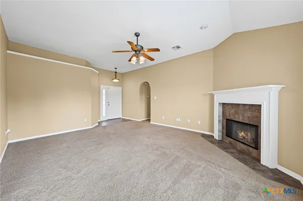 a view of an empty room with a fireplace