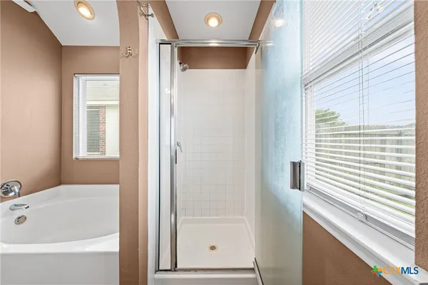 a bathroom with a bathtub and a window