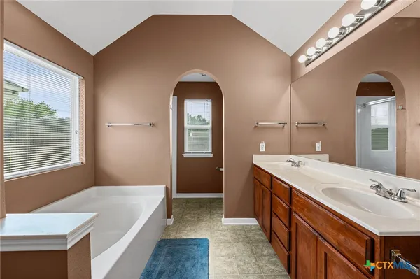a spacious bathroom with a double vanity sink and a mirror
