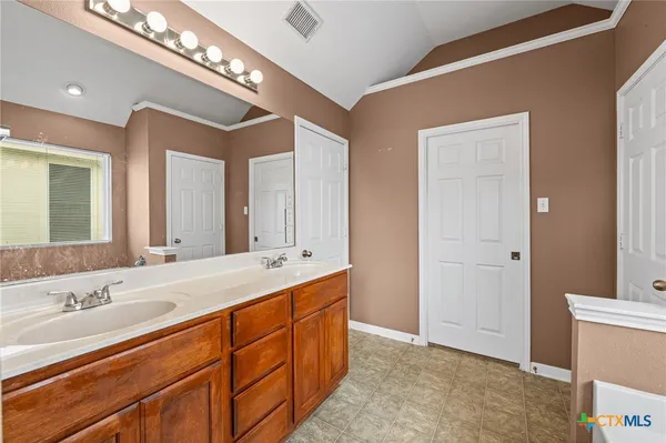 a bathroom with a tub sink and mirror