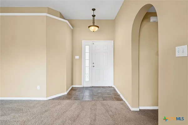 a view of a hallway with front door
