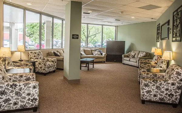 a bedroom with furniture and a large window