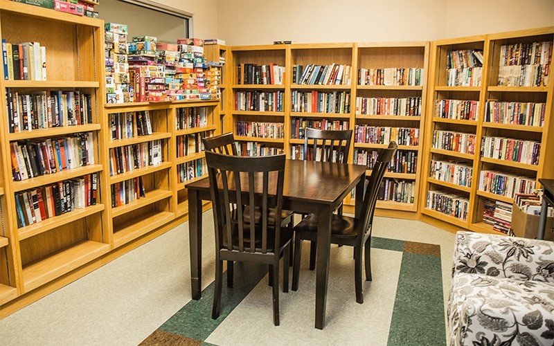 404 St Louis Avenue Excelsior Springs, MO 64024 - Photo 6 of 12 a view of a workspace room with furniture and book shelf