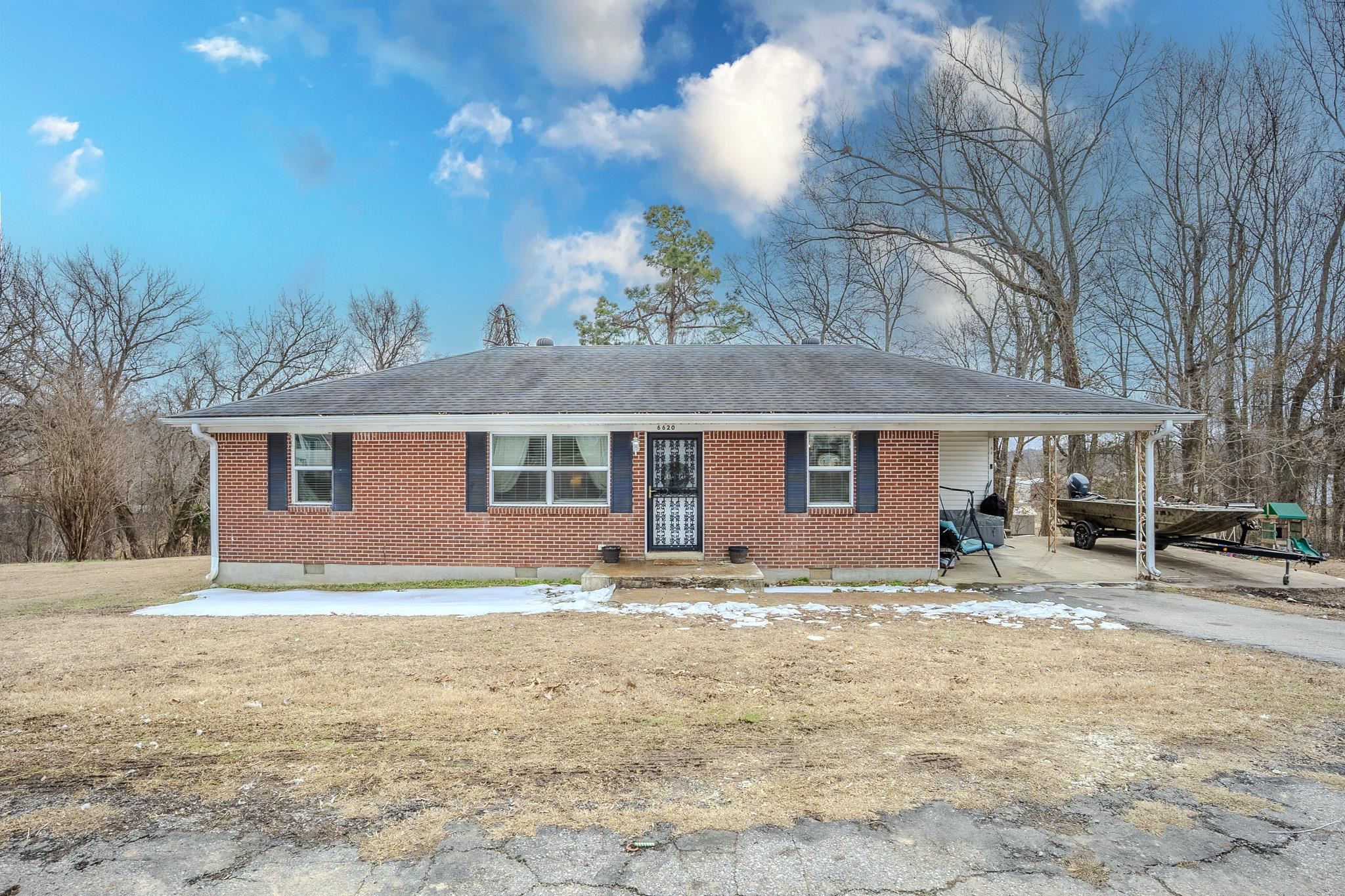 a house view with a sitting space and garden