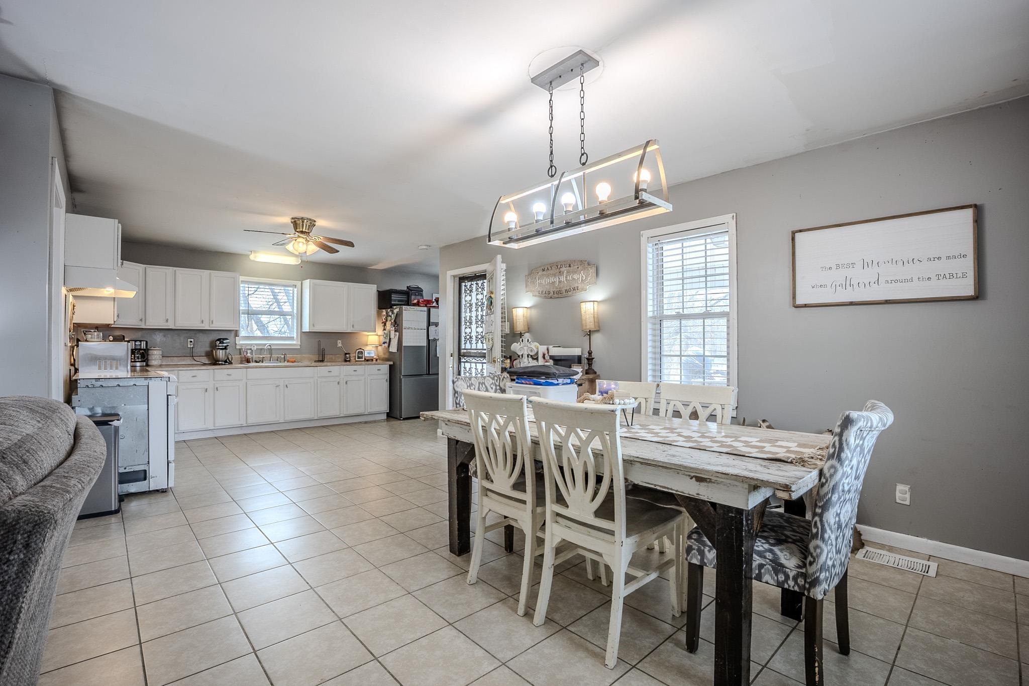 6620 Conner Whitefield Road Ripley, TN 38063 - Photo 3 of 13 a view of a dining room and livingroom with furniture a kitchen and chandelier