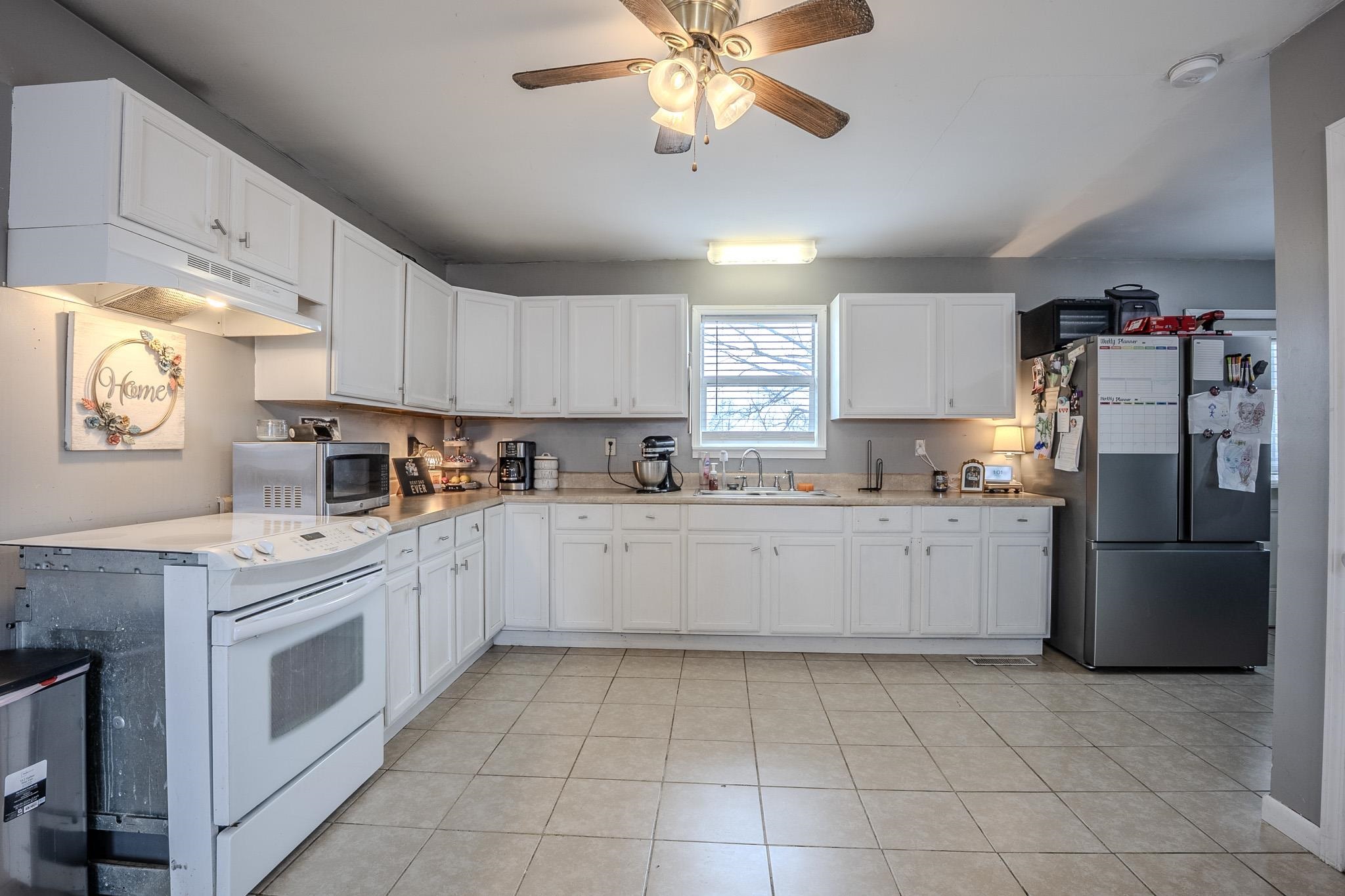 6620 Conner Whitefield Road Ripley, TN 38063 - Photo 4 of 13 a kitchen with a refrigerator sink and cabinets