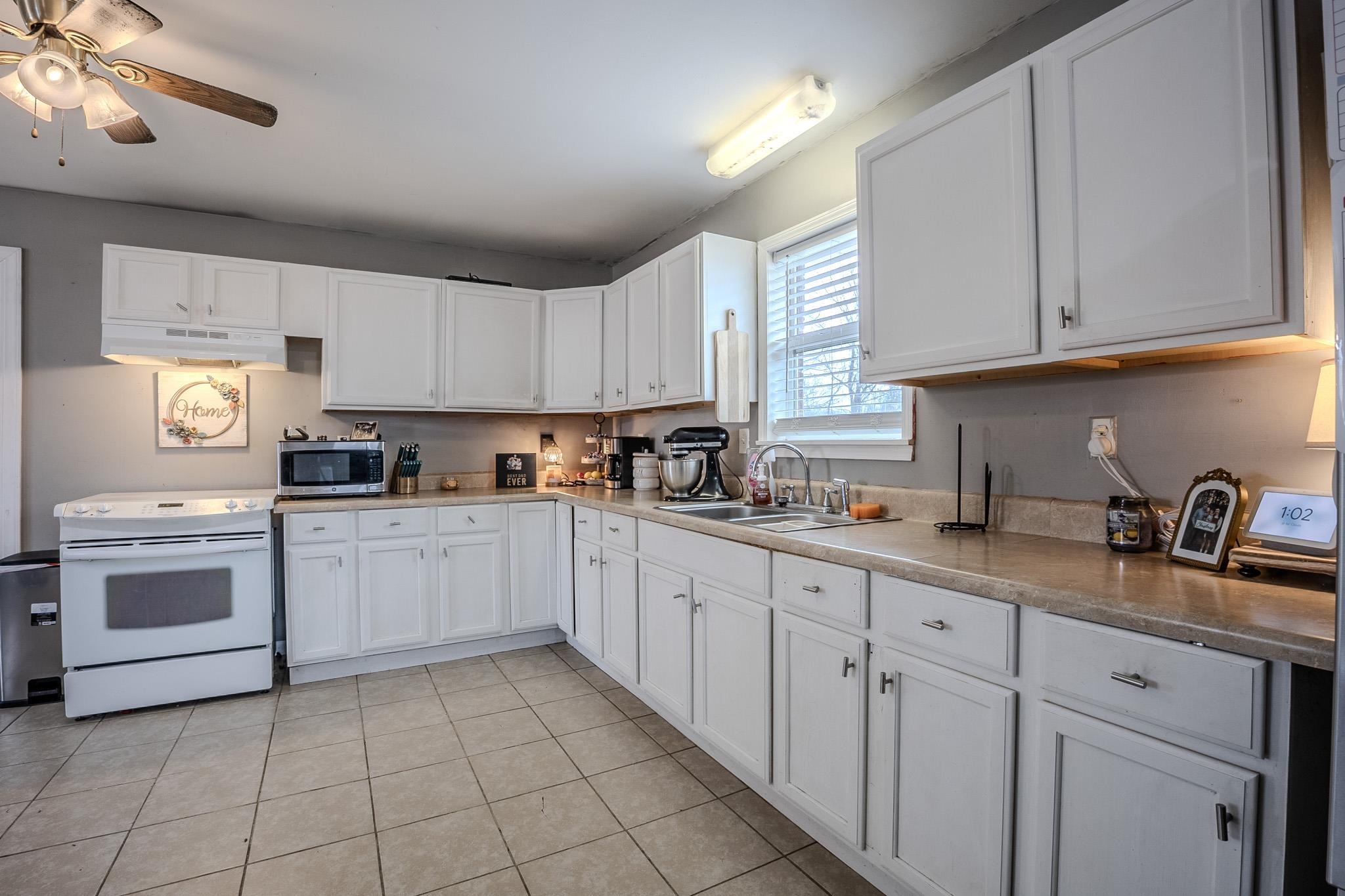 6620 Conner Whitefield Road Ripley, TN 38063 - Photo 5 of 13 a kitchen with cabinets appliances a sink and a window