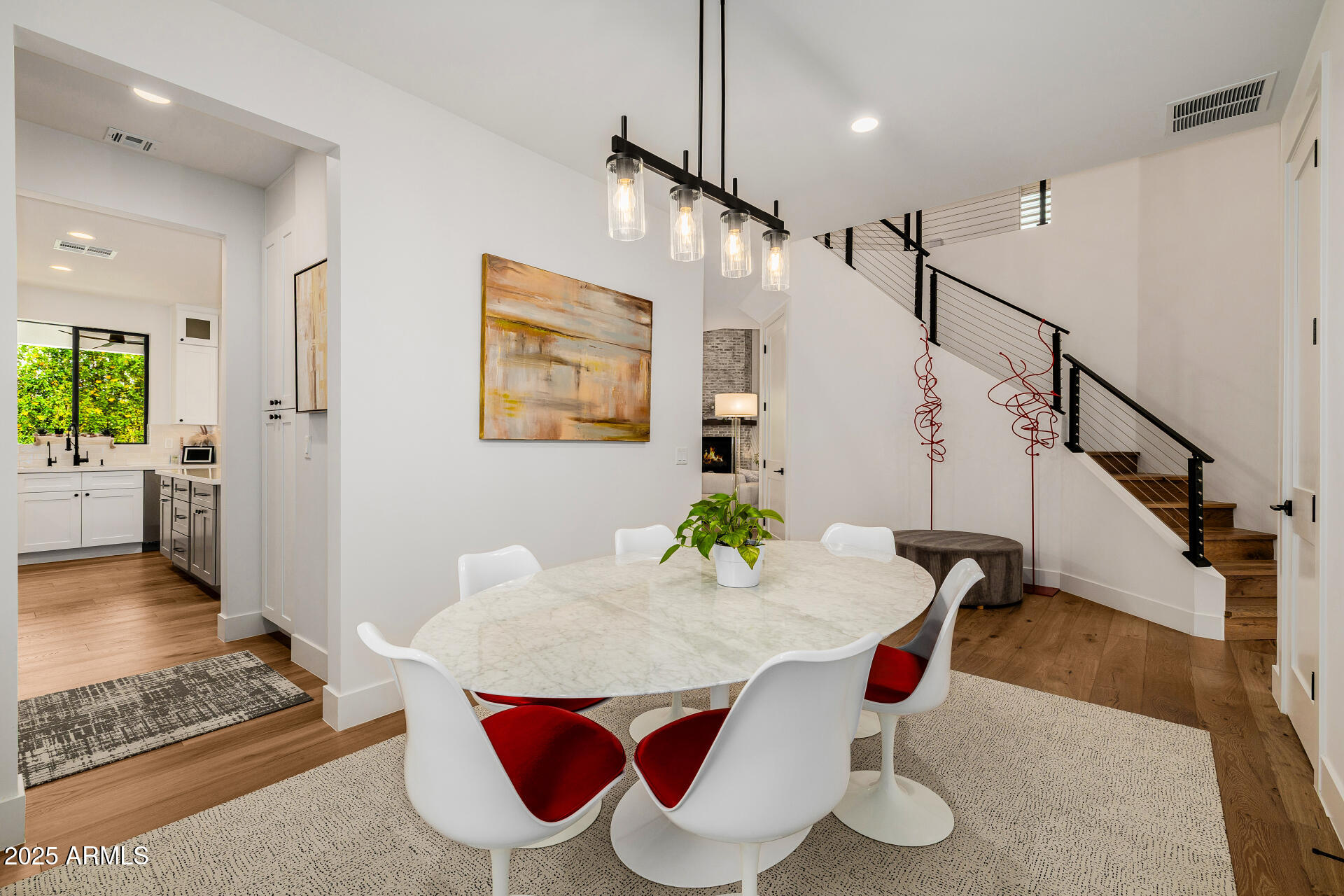 7245 North 13th Lane Phoenix, AZ 85021 - Photo 9 of 40 a view of a dining room with furniture and wooden floor