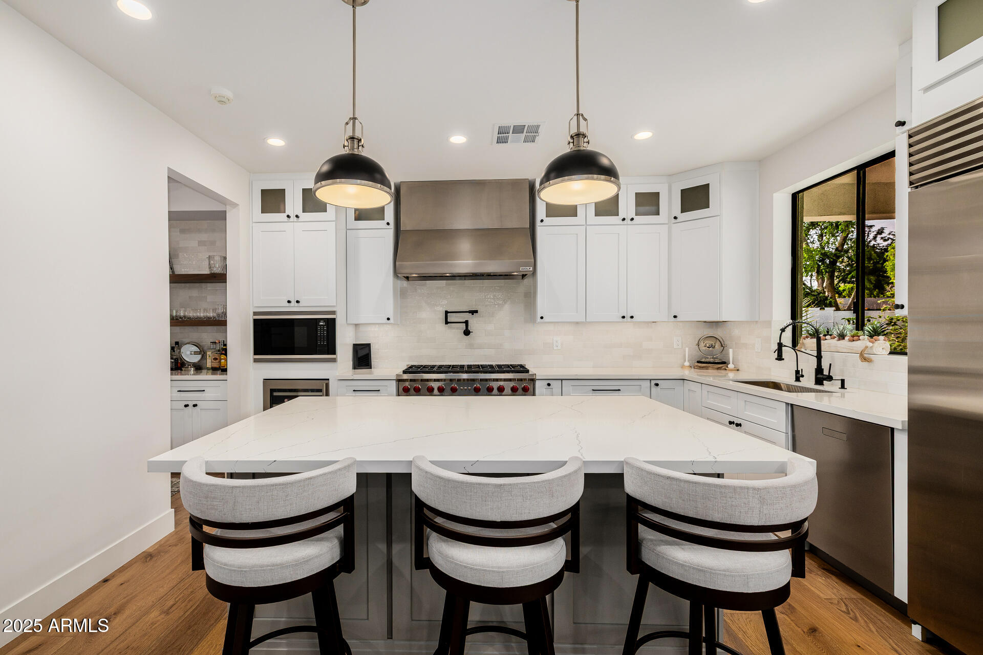 7245 North 13th Lane Phoenix, AZ 85021 - Photo 10 of 40 a kitchen with stainless steel appliances a dining table chairs and stove