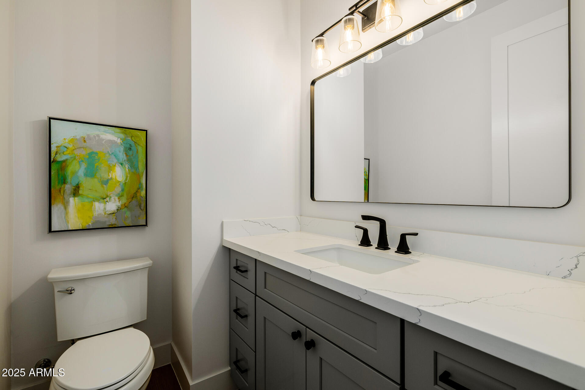 7245 North 13th Lane Phoenix, AZ 85021 - Photo 12 of 40 a bathroom with a toilet sink and mirror
