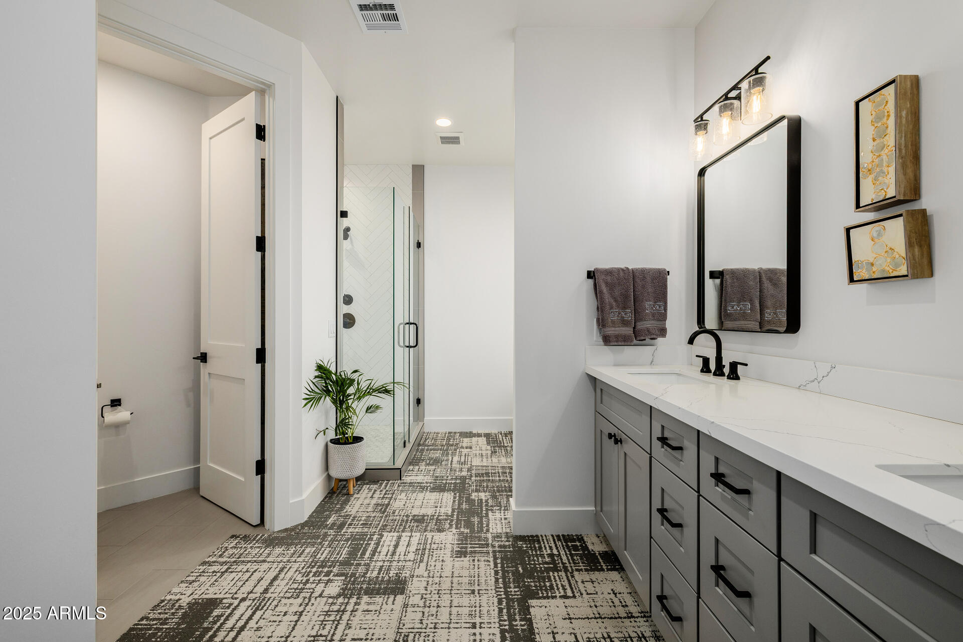 7245 North 13th Lane Phoenix, AZ 85021 - Photo 17 of 40 a bathroom with a double vanity sink a mirror and a shower