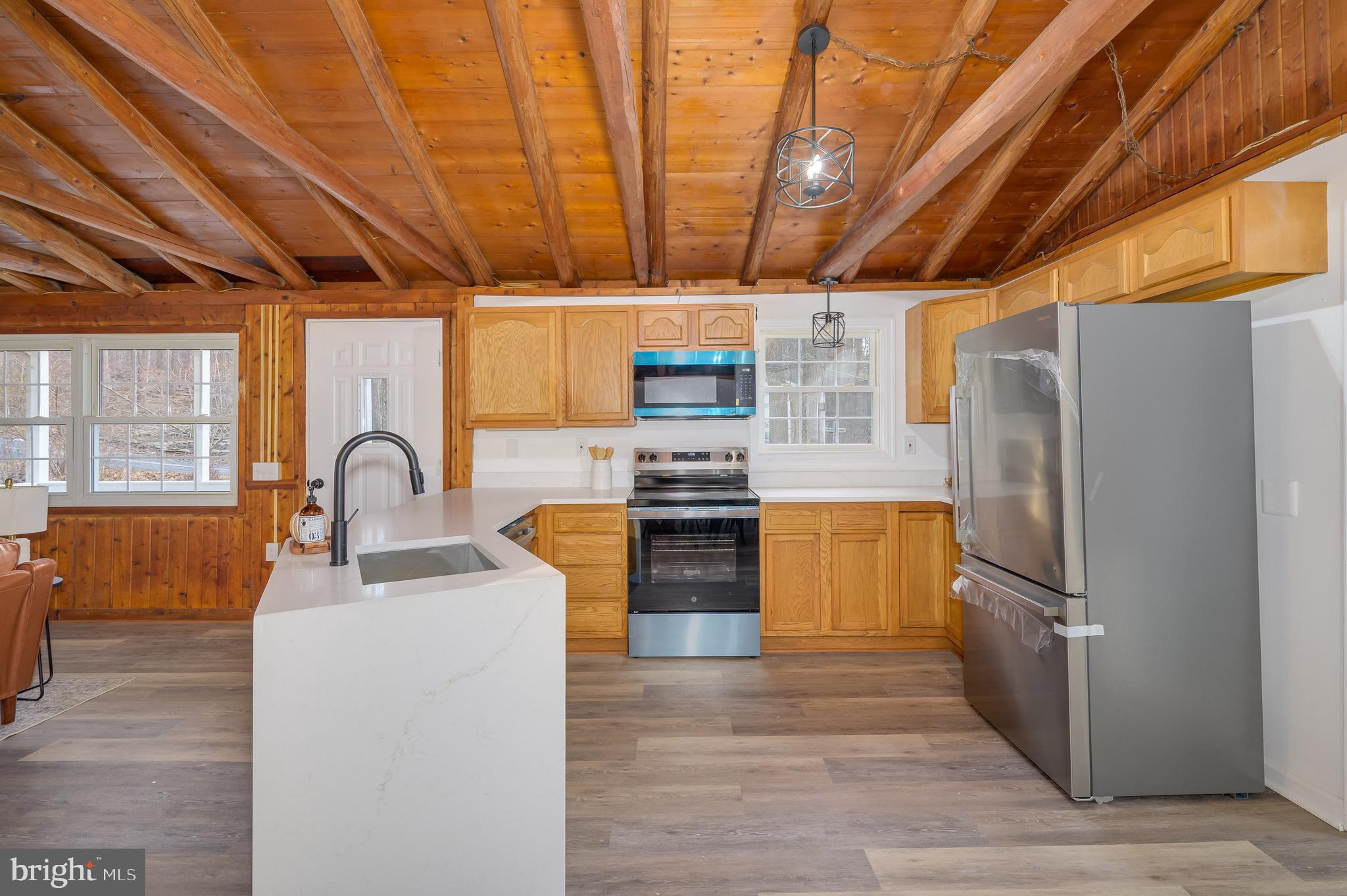 131 Flop Ear Road Harpers Ferry, WV 25425 - Photo 12 of 24 a kitchen with granite countertop wooden cabinets and stainless steel appliances