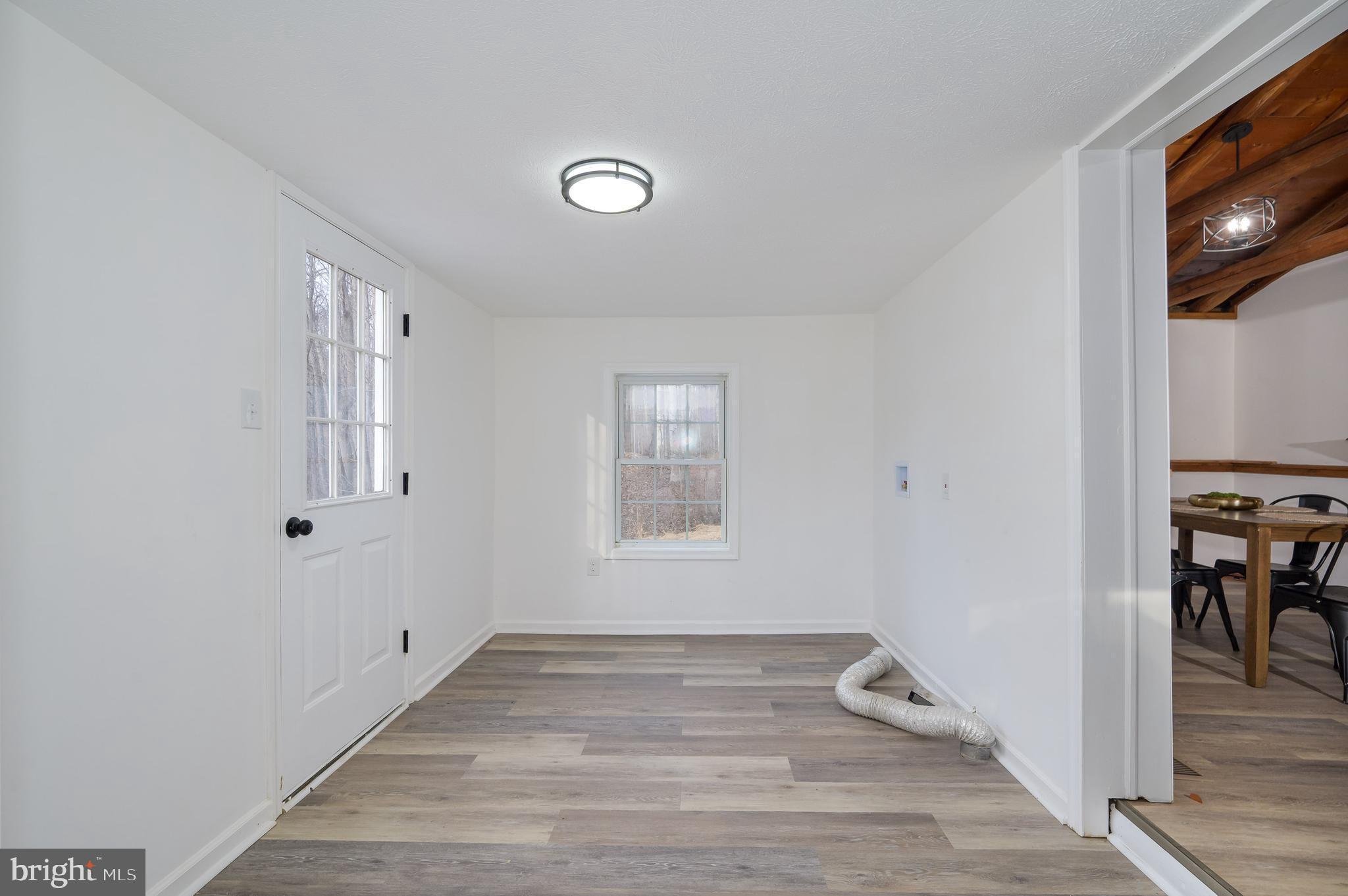 131 Flop Ear Road Harpers Ferry, WV 25425 - Photo 13 of 24 a view of an empty room with window and wooden floor