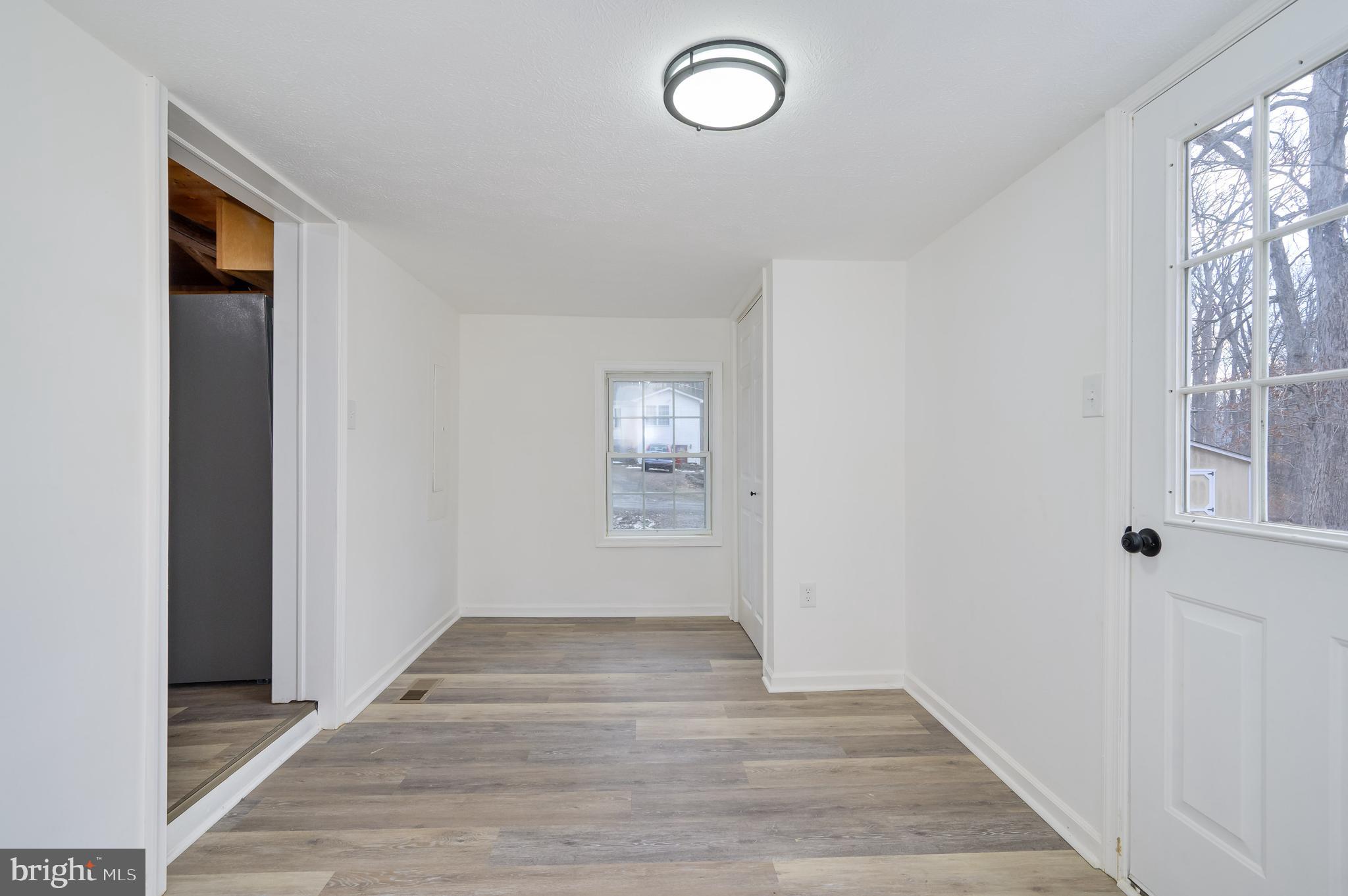 131 Flop Ear Road Harpers Ferry, WV 25425 - Photo 14 of 24 a view of an empty room with wooden floor and a window