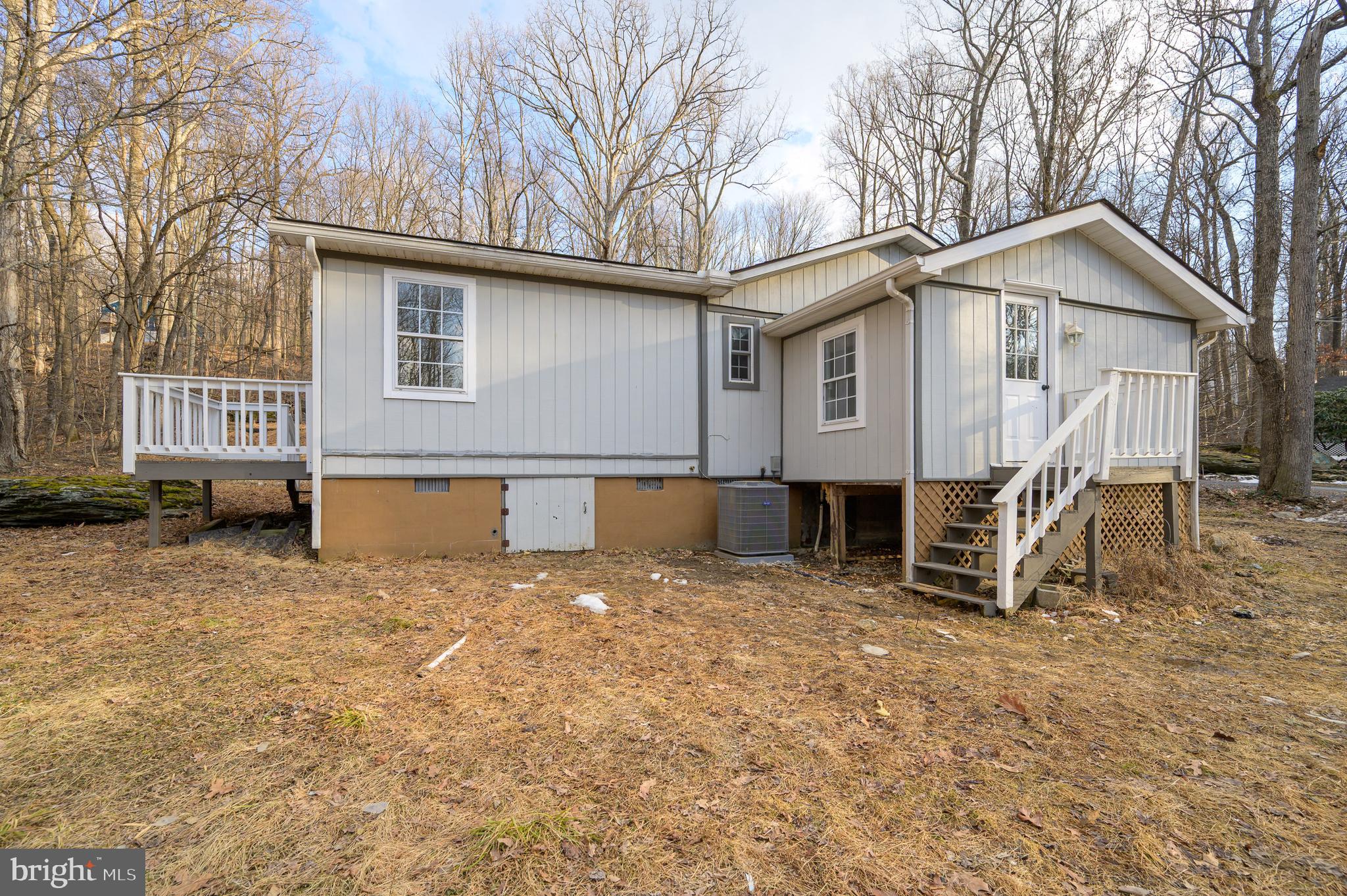 131 Flop Ear Road Harpers Ferry, WV 25425 - Photo 20 of 24 a view of a house with backyard and a tree