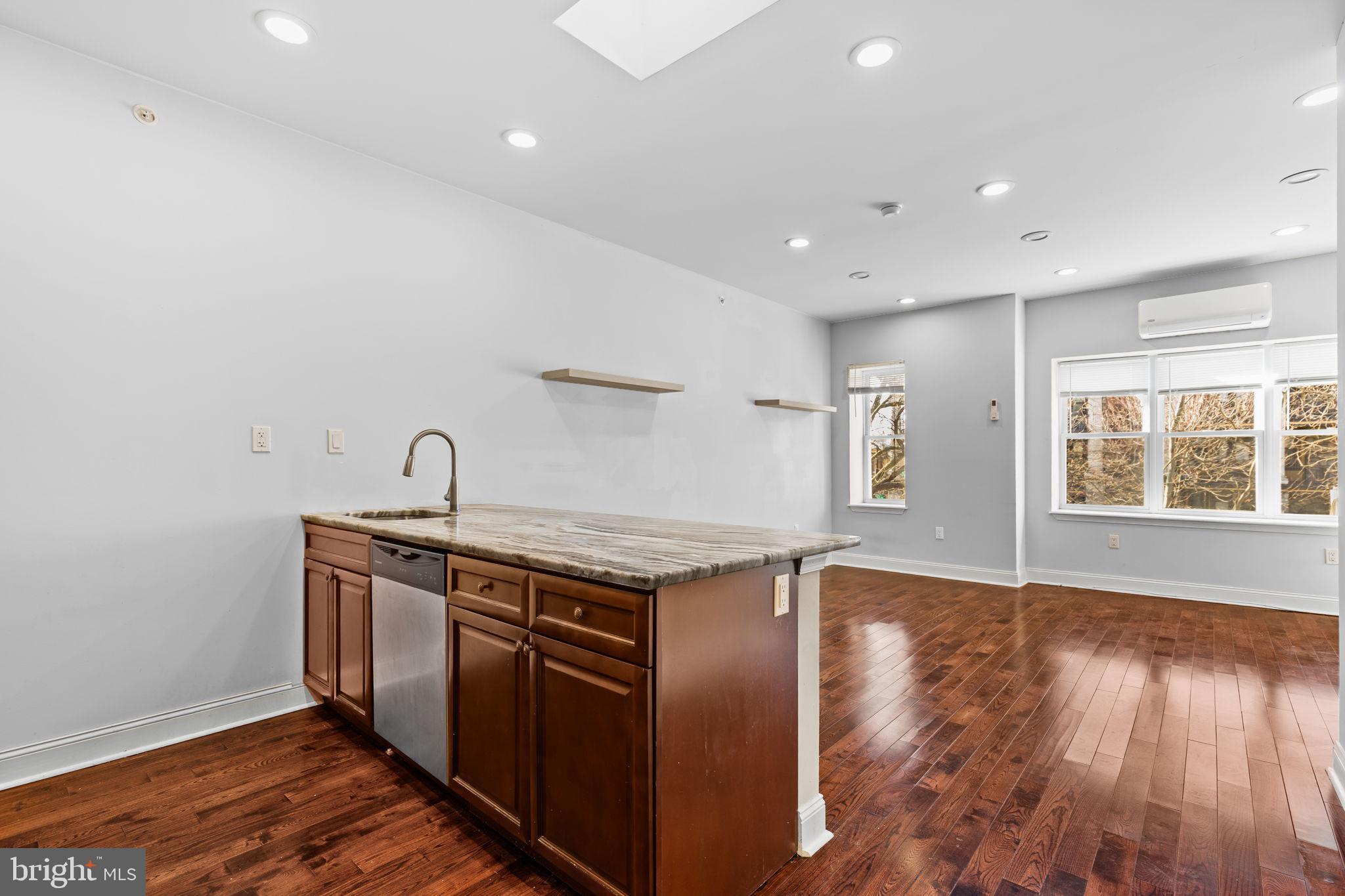 a kitchen with stainless steel appliances granite countertop a stove and a sink