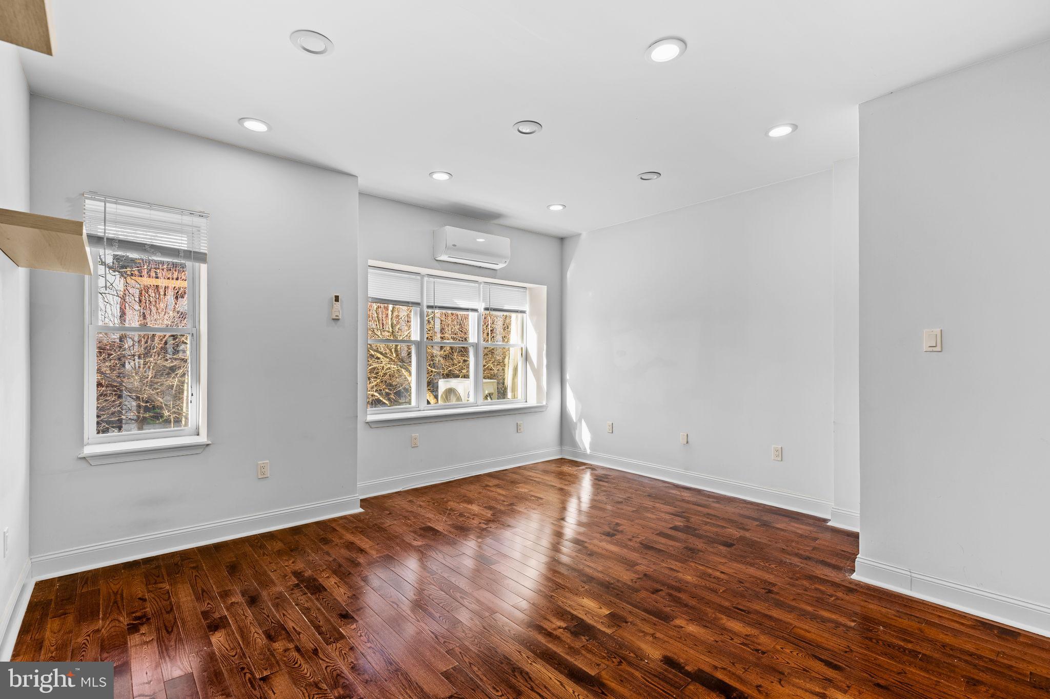 4633 Walnut Street, Unit D Philadelphia, PA 19139 - Photo 3 of 10 a view of an empty room with wooden floor and a window