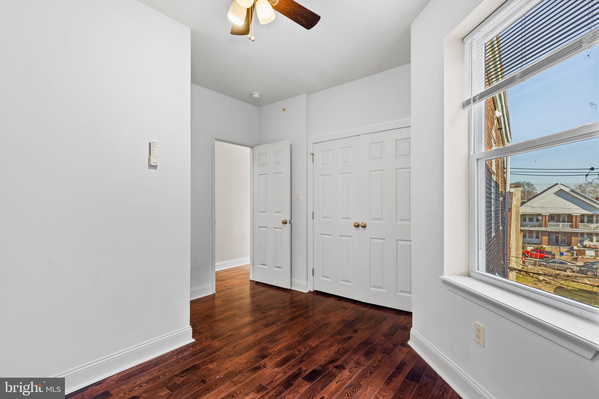 4633 Walnut Street, Unit D Philadelphia, PA 19139 - Photo 9 of 10 wooden floor in an empty room with a window