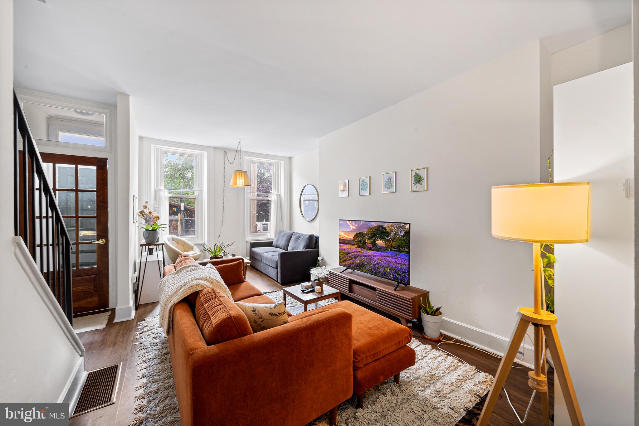 107 Master Street Philadelphia, PA 19122 - Photo 1 of 24 a living room with furniture and a lamp