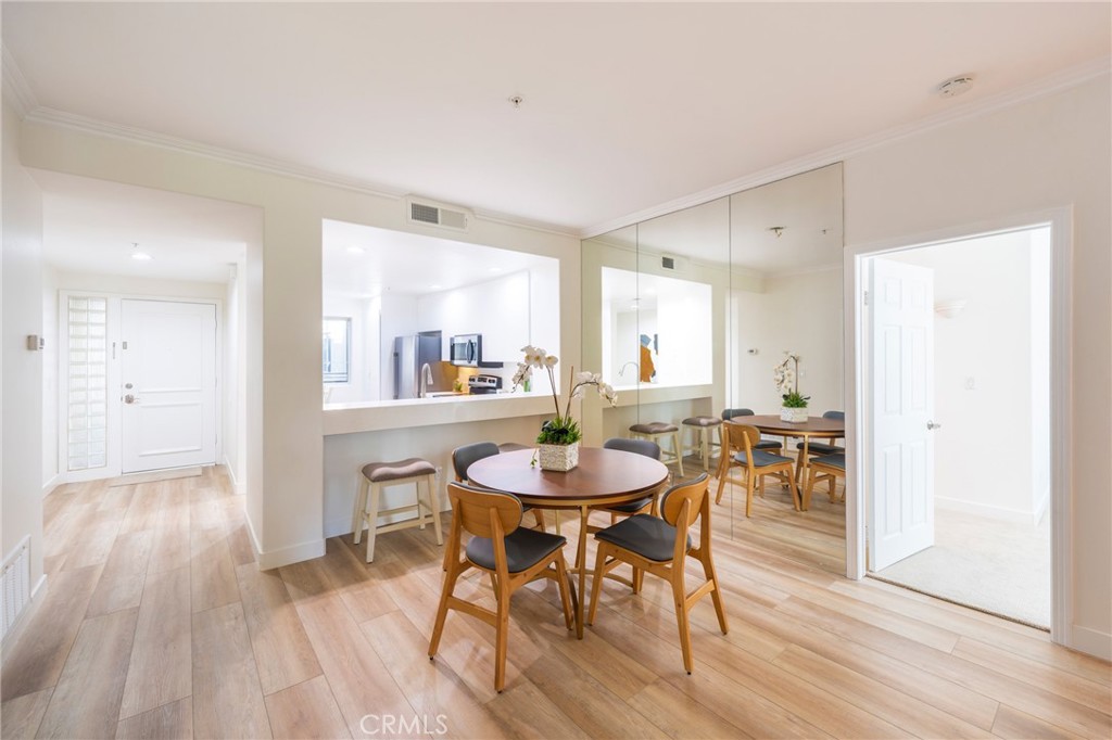 2233 Martin, Unit 202 Irvine, CA 92612 - Photo 12 of 33 a view of a dining room with furniture and wooden floor