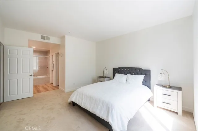 a bedroom with a bed and a view of bathroom