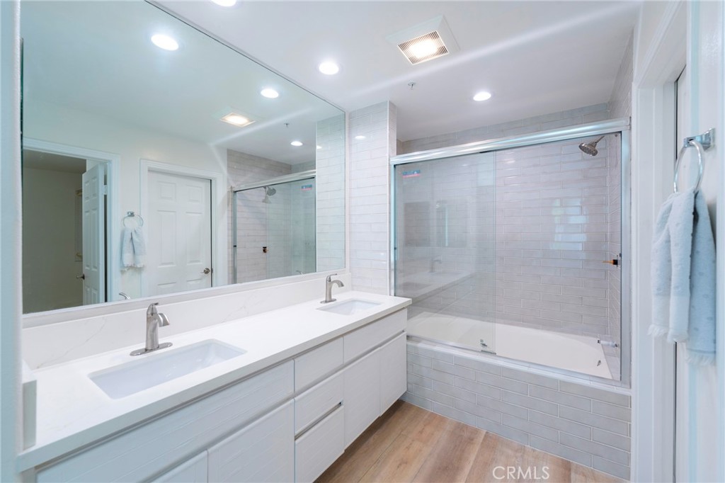 2233 Martin, Unit 202 Irvine, CA 92612 - Photo 16 of 33 a bathroom with a double vanity sink mirror double and bathtub