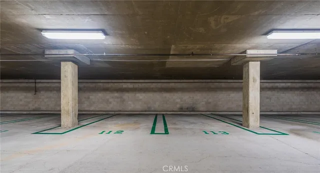a view of a sign board with flower plants and wooden fence