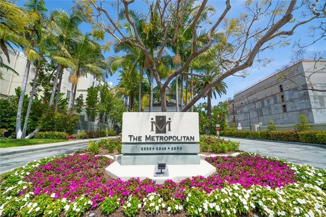 a view of a pathway with a building and potted plants