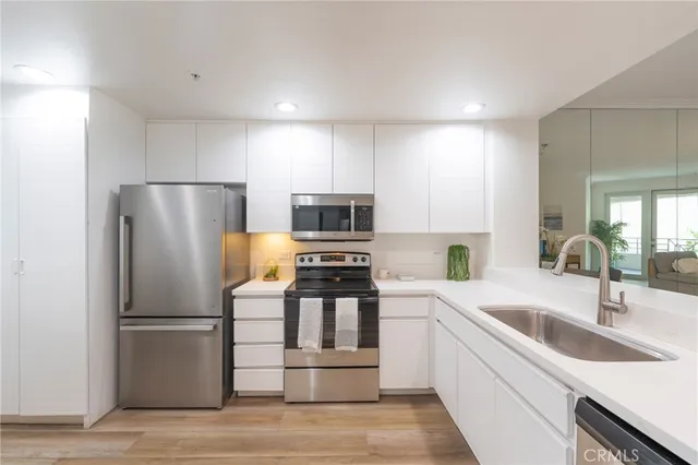 a kitchen with a refrigerator sink and stove
