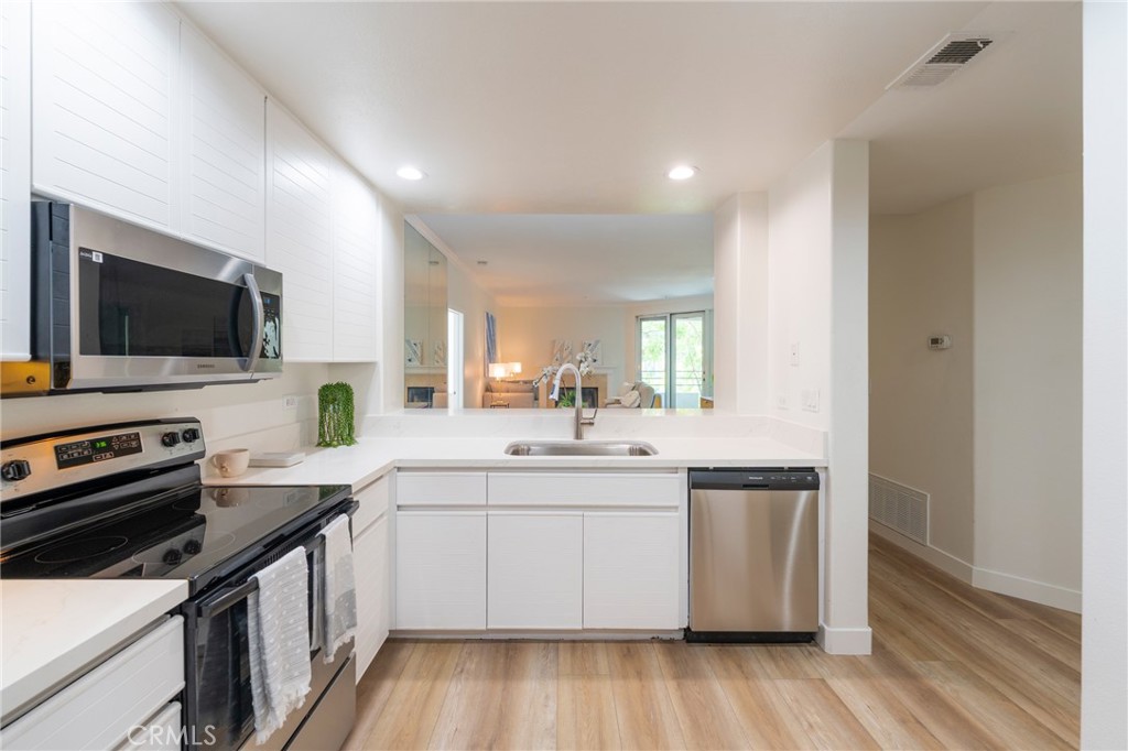 2233 Martin, Unit 202 Irvine, CA 92612 - Photo 9 of 33 a kitchen with a sink stove and microwave