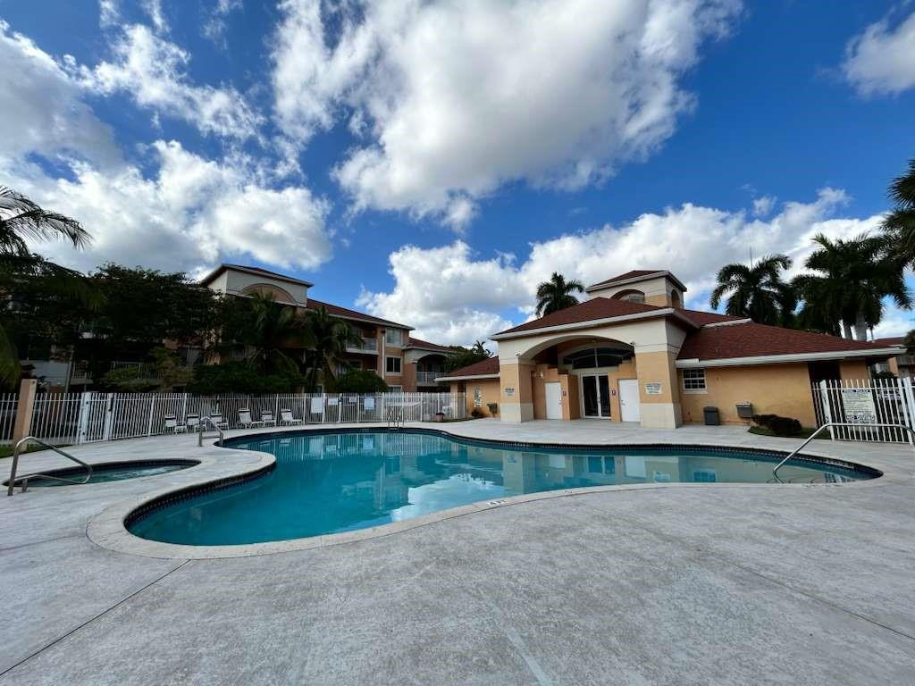 6900 Southwest 39th Street, Unit 305J Davie, FL 33314 - Photo 5 of 20 a view of a house with swimming pool and sitting area