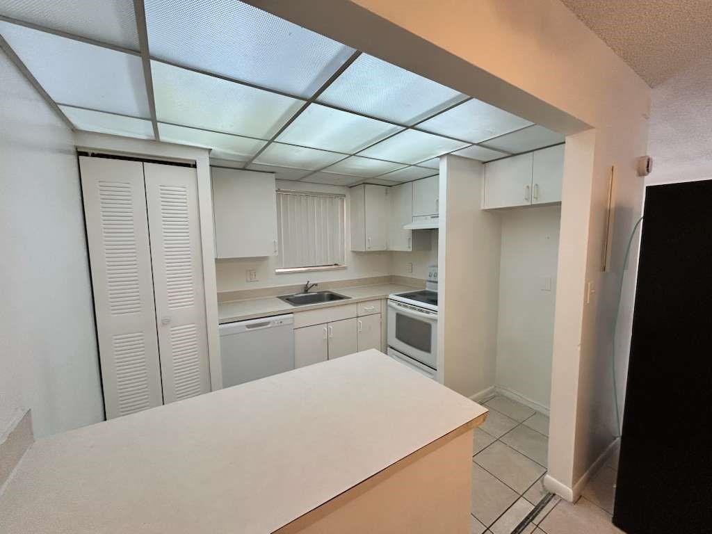 6900 Southwest 39th Street, Unit 305J Davie, FL 33314 - Photo 8 of 20 a kitchen with stainless steel appliances a refrigerator and a stove top oven