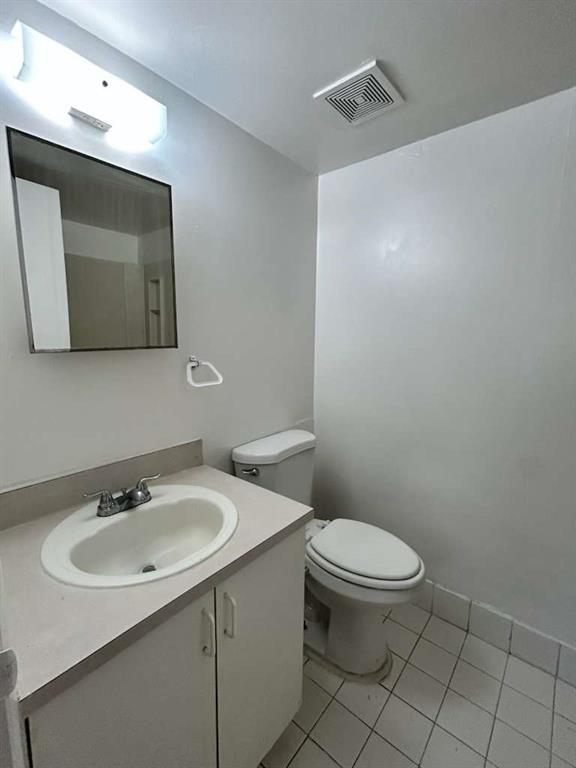 6900 Southwest 39th Street, Unit 305J Davie, FL 33314 - Photo 10 of 20 a bathroom with a toilet sink and mirror