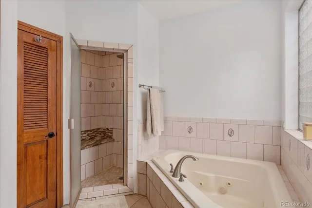 a bathroom with a bathtub and shower