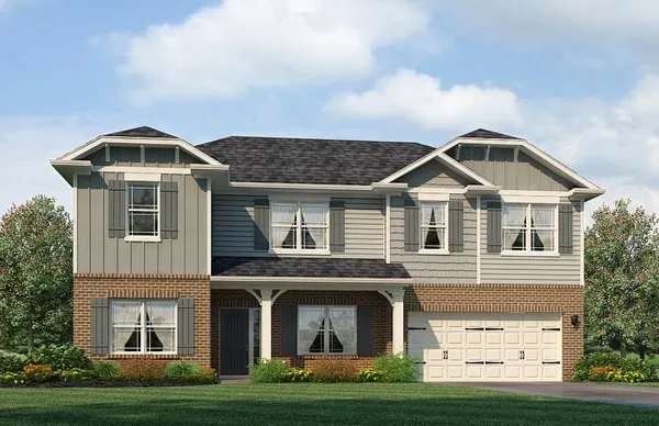 a front view of a house with a yard and garage
