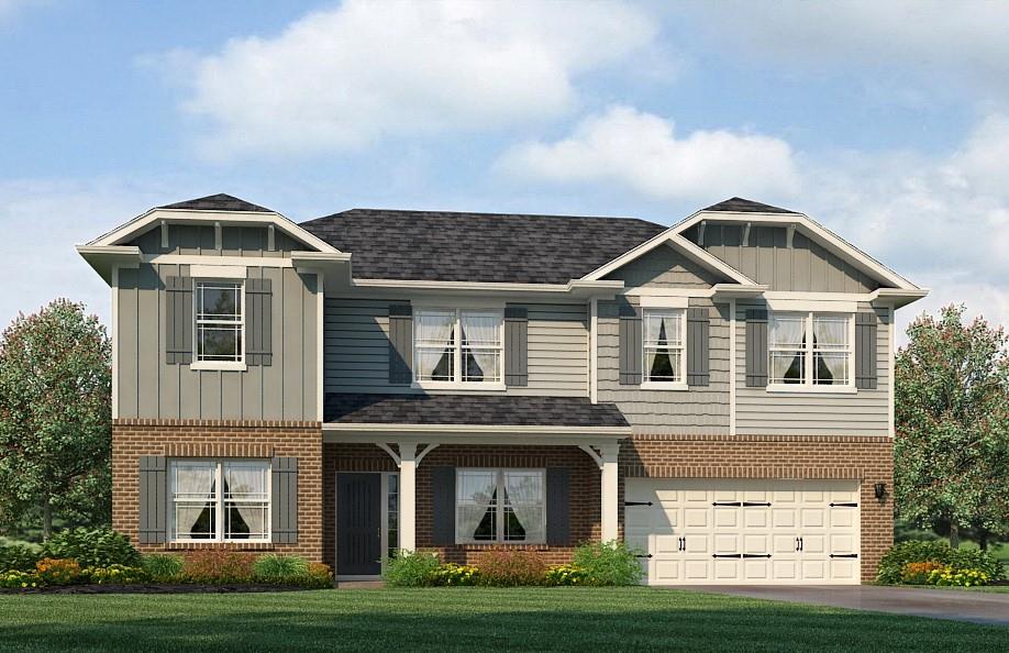 a front view of a house with a yard and garage